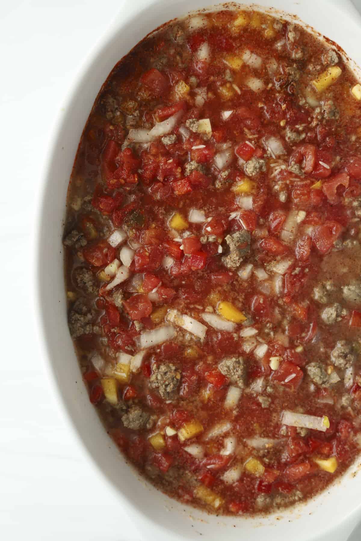 baking dish of tomatoes peppers and ground beef 