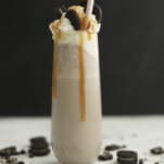 side view of oreo frappuccino with caramel dripping down the side and straw
