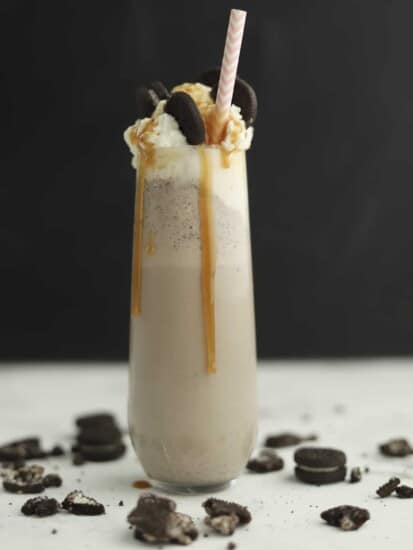 side view of oreo frappuccino with caramel dripping down the side and straw
