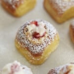 overhead image of air fried strawberry cream cheese stuffed Hawaiian rolls dusted with powdered sugar