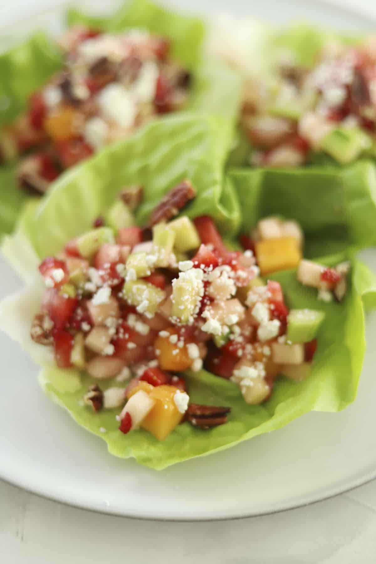 fruit salad in lettuce cups on a platter