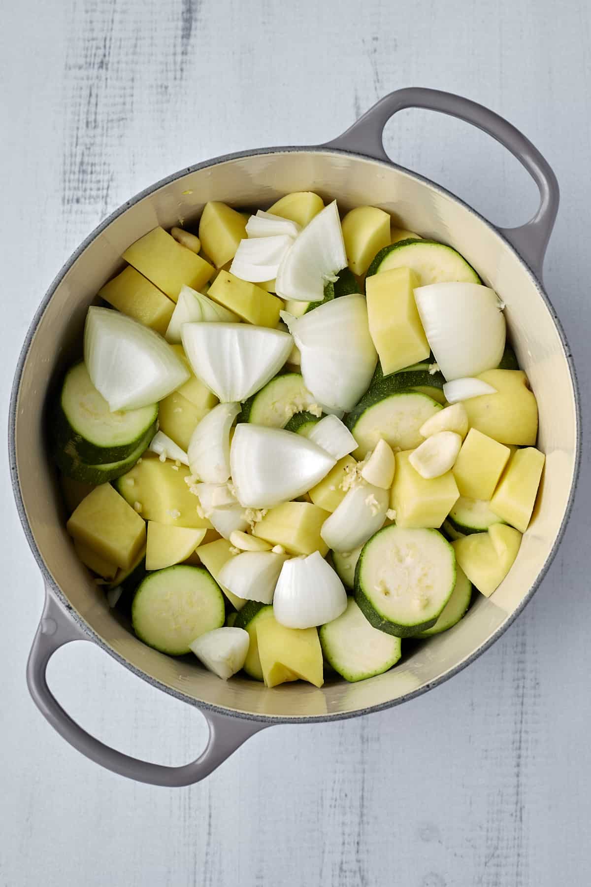 onions, zucchini, potatoes, and garlic in a large pot