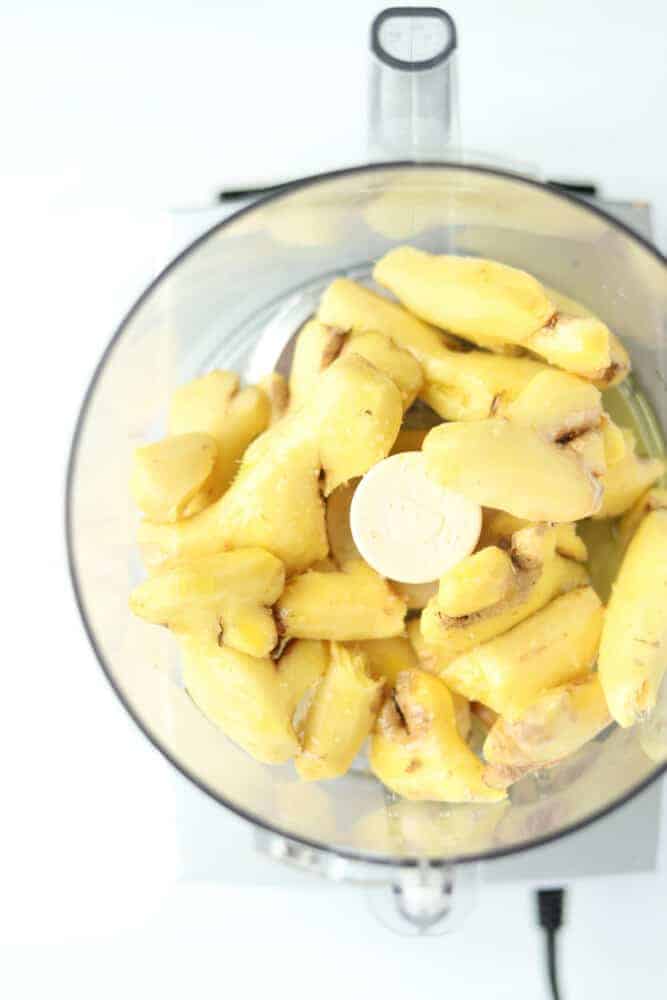 overhead image of peeled ginger in a food processor 