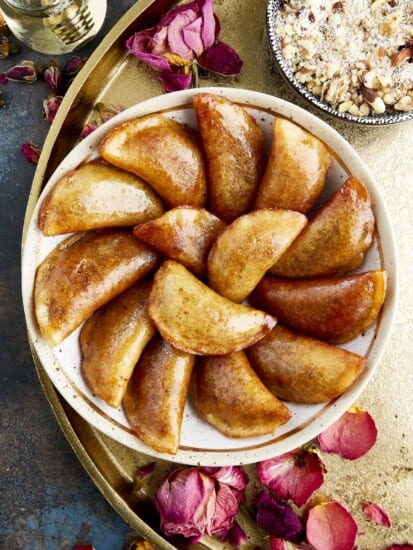 Overhead image of a bowl of qatayef with nuts.