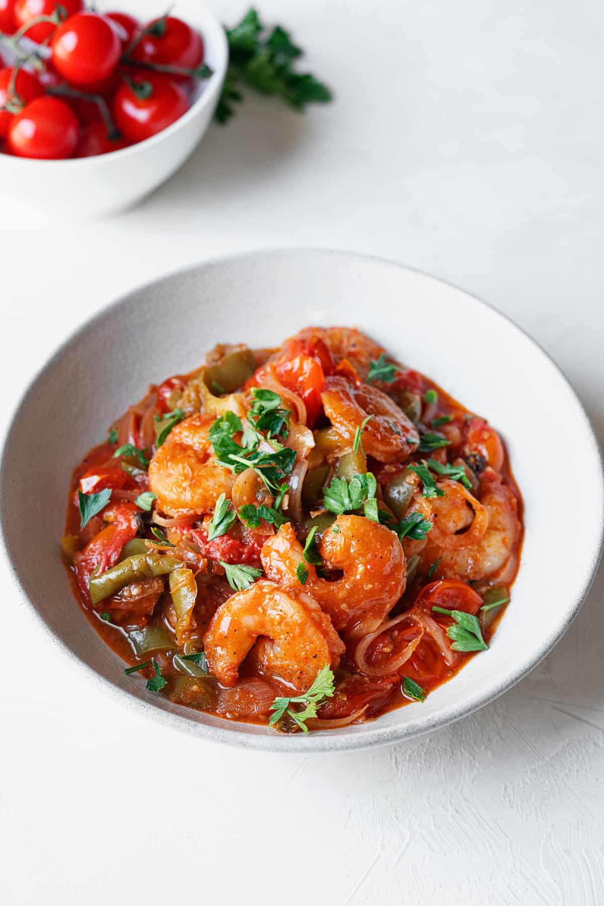 overhead of shrimp and tomato in a baking dish