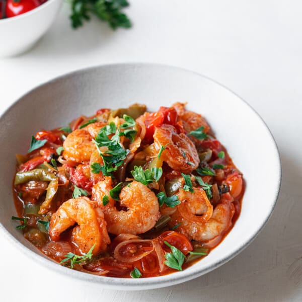 a bowl of baked shrimp in tomato sauce