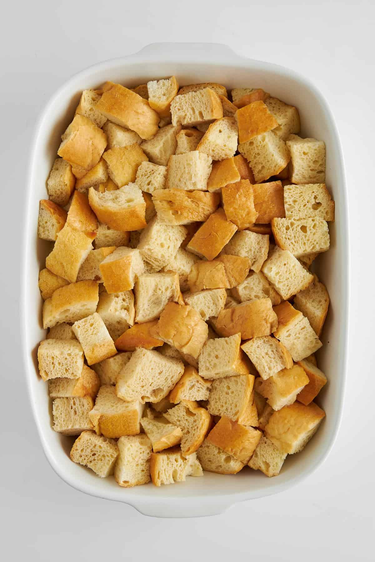 Bread cubes in a baking dish.
