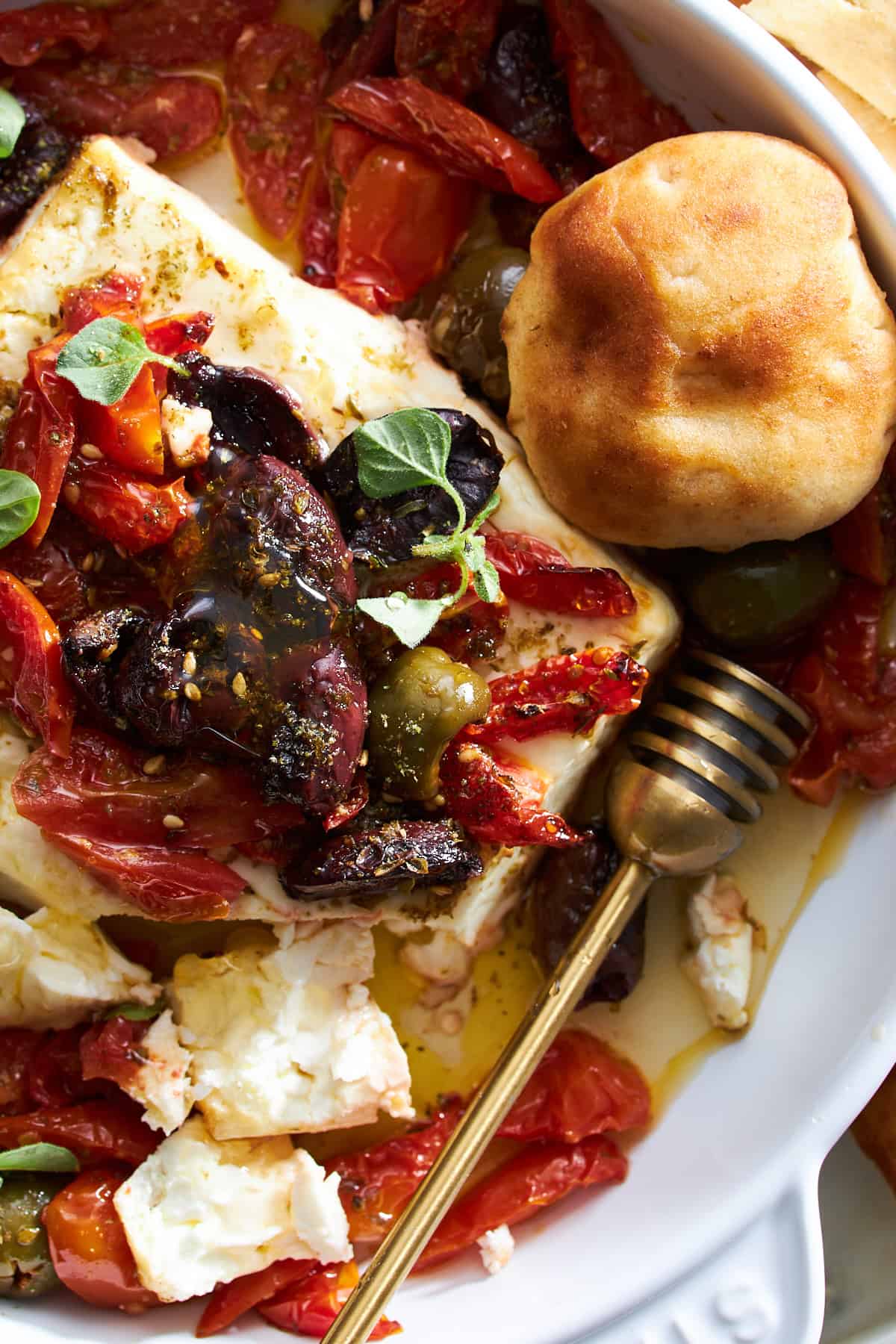 Close up image of Mediterranean baked feta dip with a pita puff.