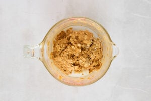 Granola cup ingredients being mixed in a bowl.