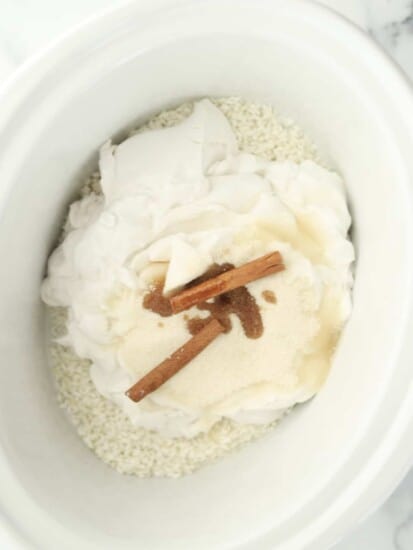 rice, coconut milk, sugar, vanilla, and cinnamon sticks in a slow cooker