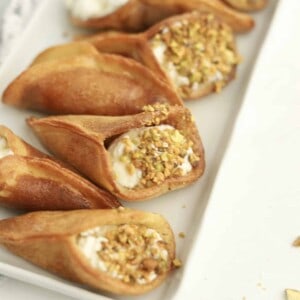 atayef with whipped cream and pistachios