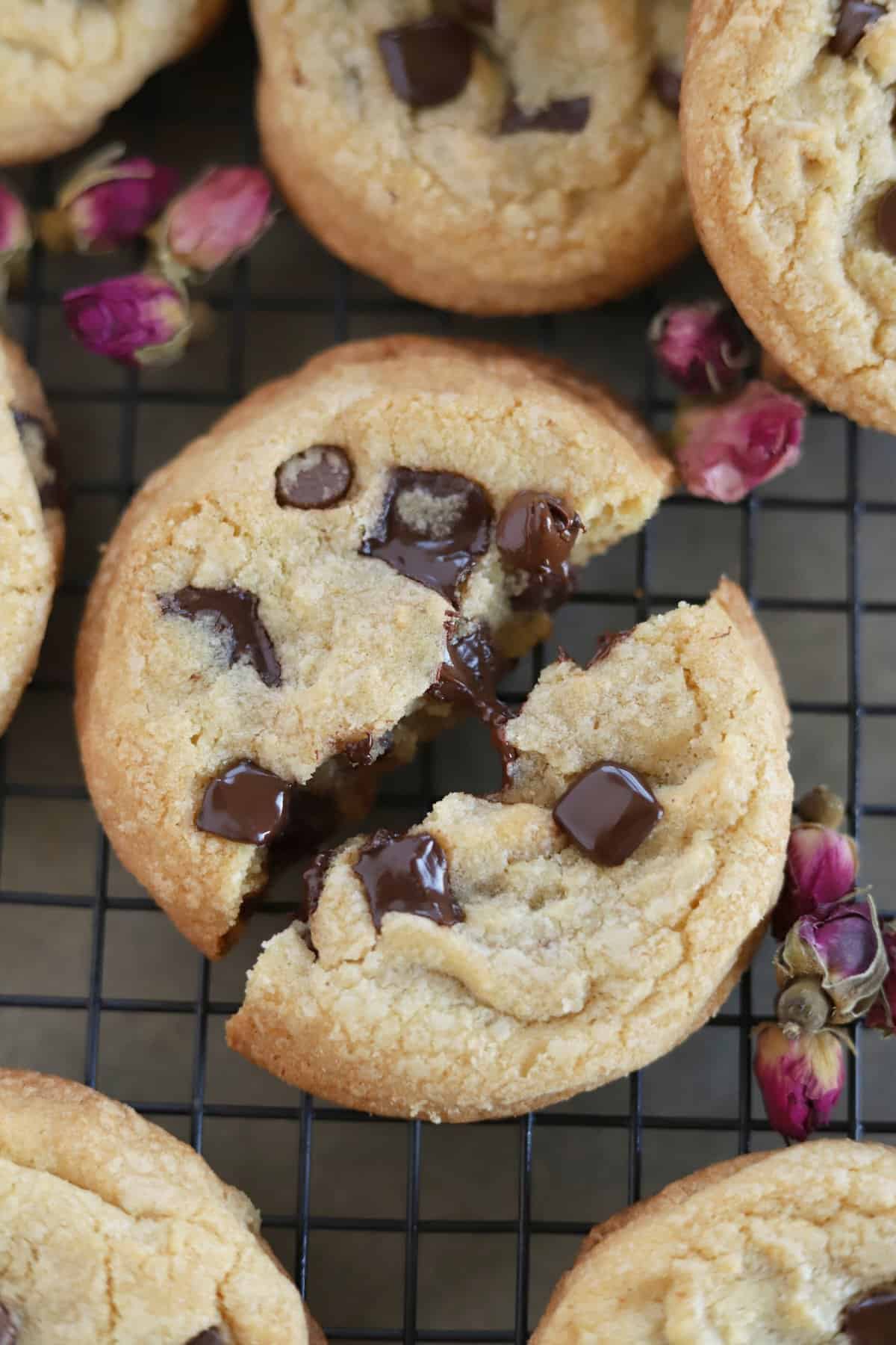 A chewy chocolate chip cookie split in half.