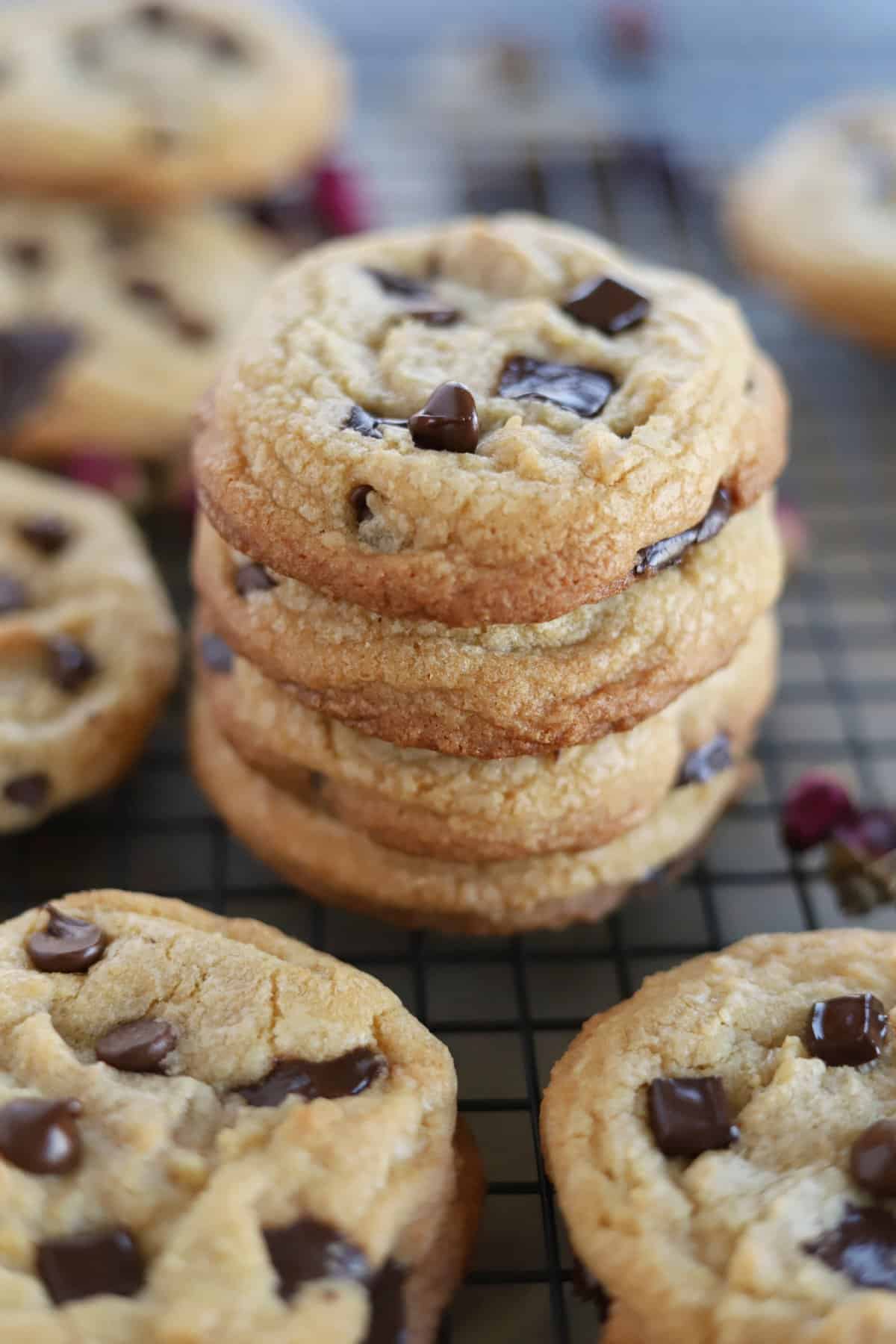 A stack of the best chewy chocolate chip cookies on a wire rack. 