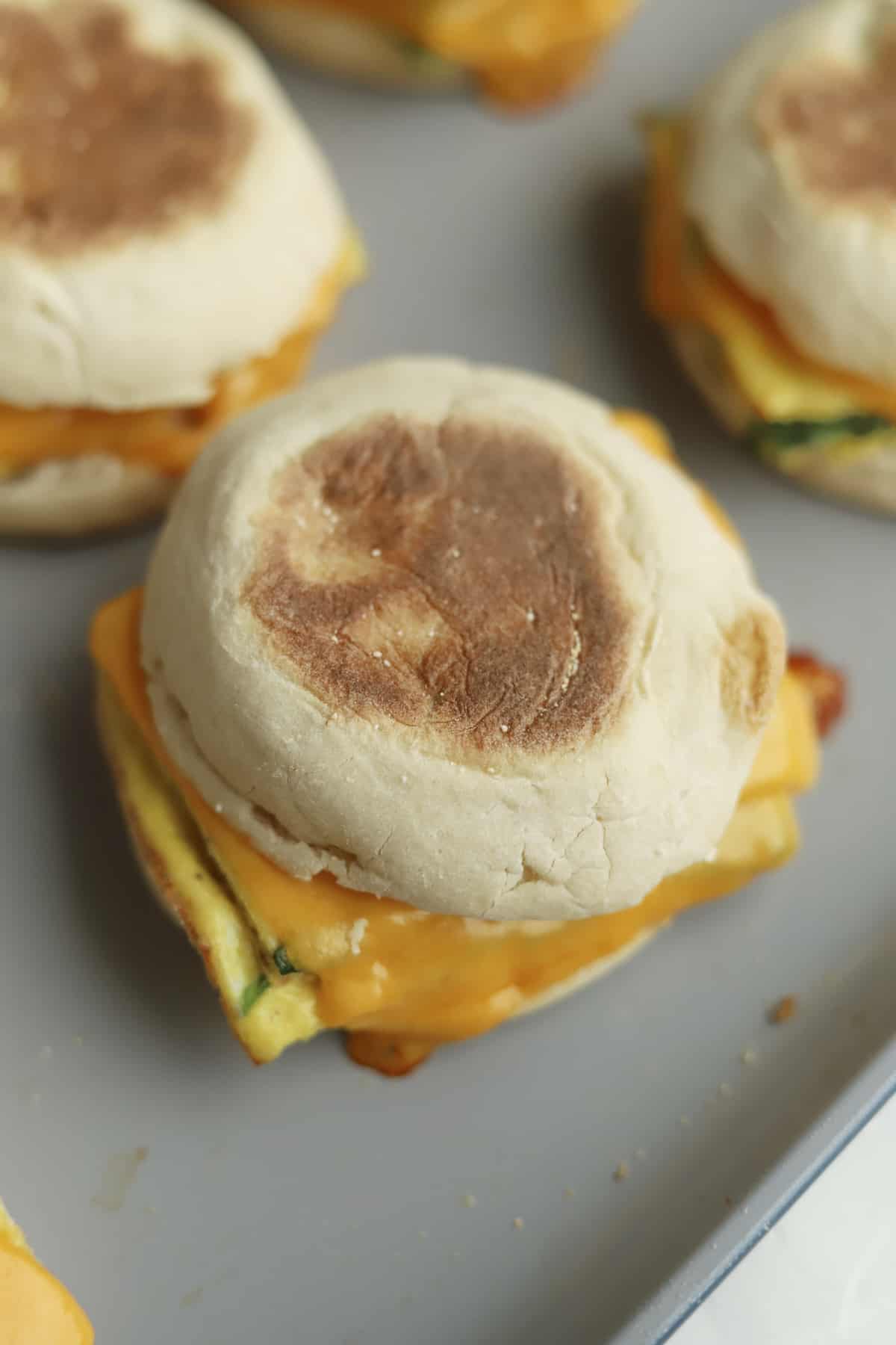 close up image of protein packed egg muffin sandwiches on a baking dish