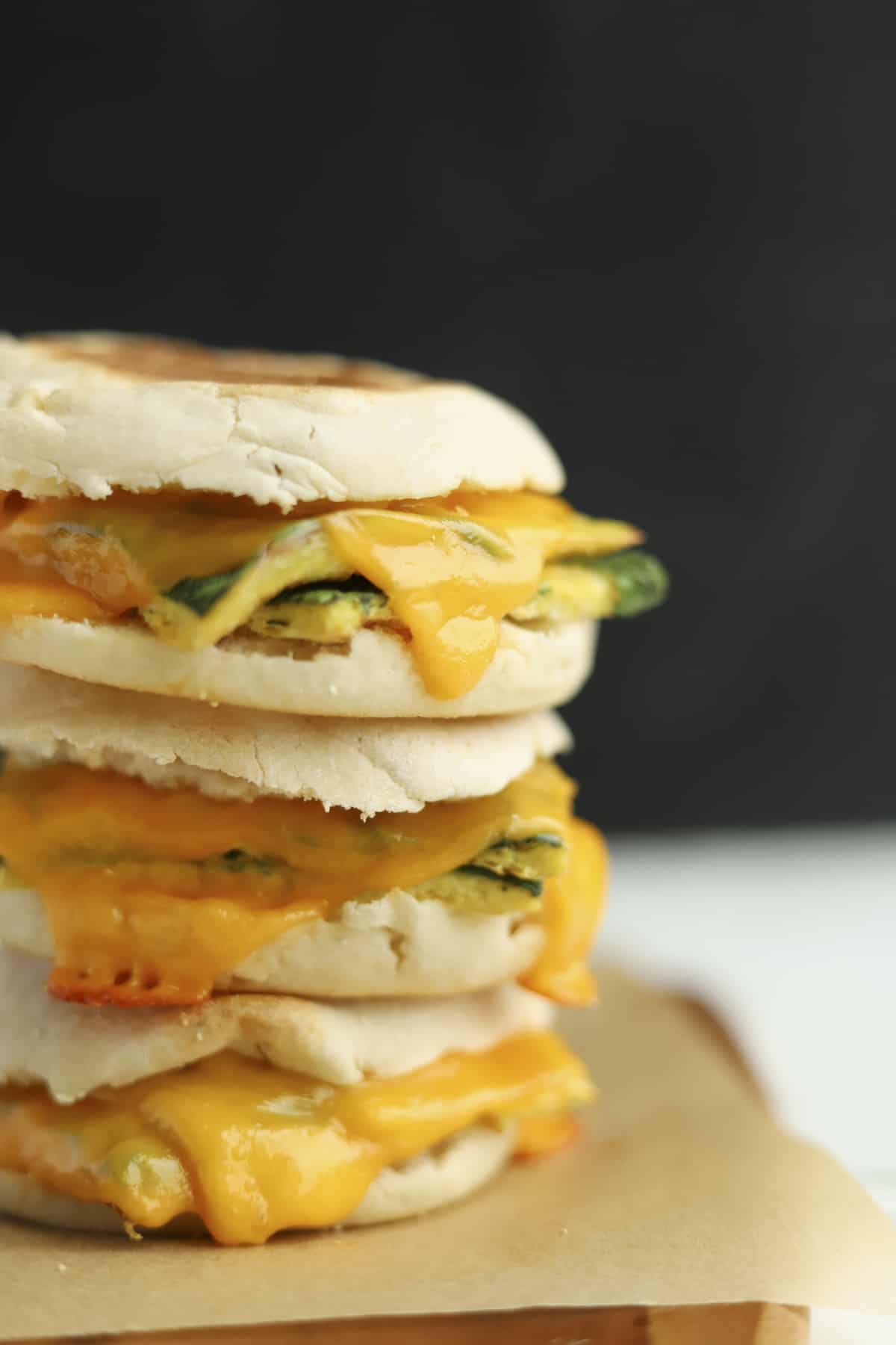 side view of three protein packed egg muffin sandwiches stacked on top of each other