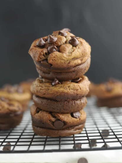 three biscoff blender muffins stacked on top of each other on a wire rack
