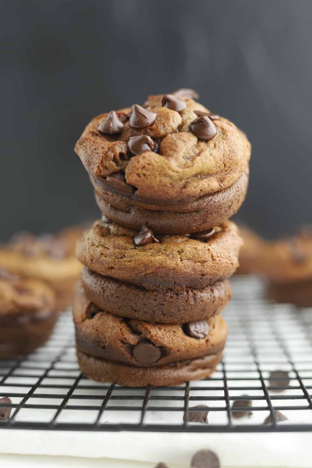 three biscoff blender muffins stacked on top of each other on a wire rack 