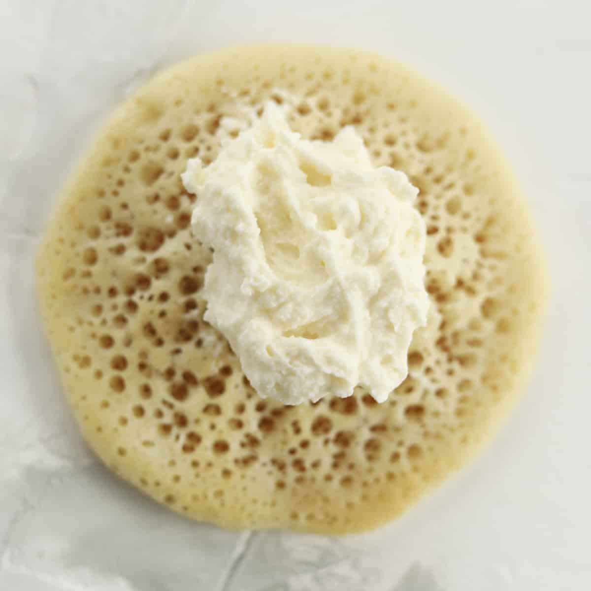 atayef dough with a dollop of cream cheese in the center