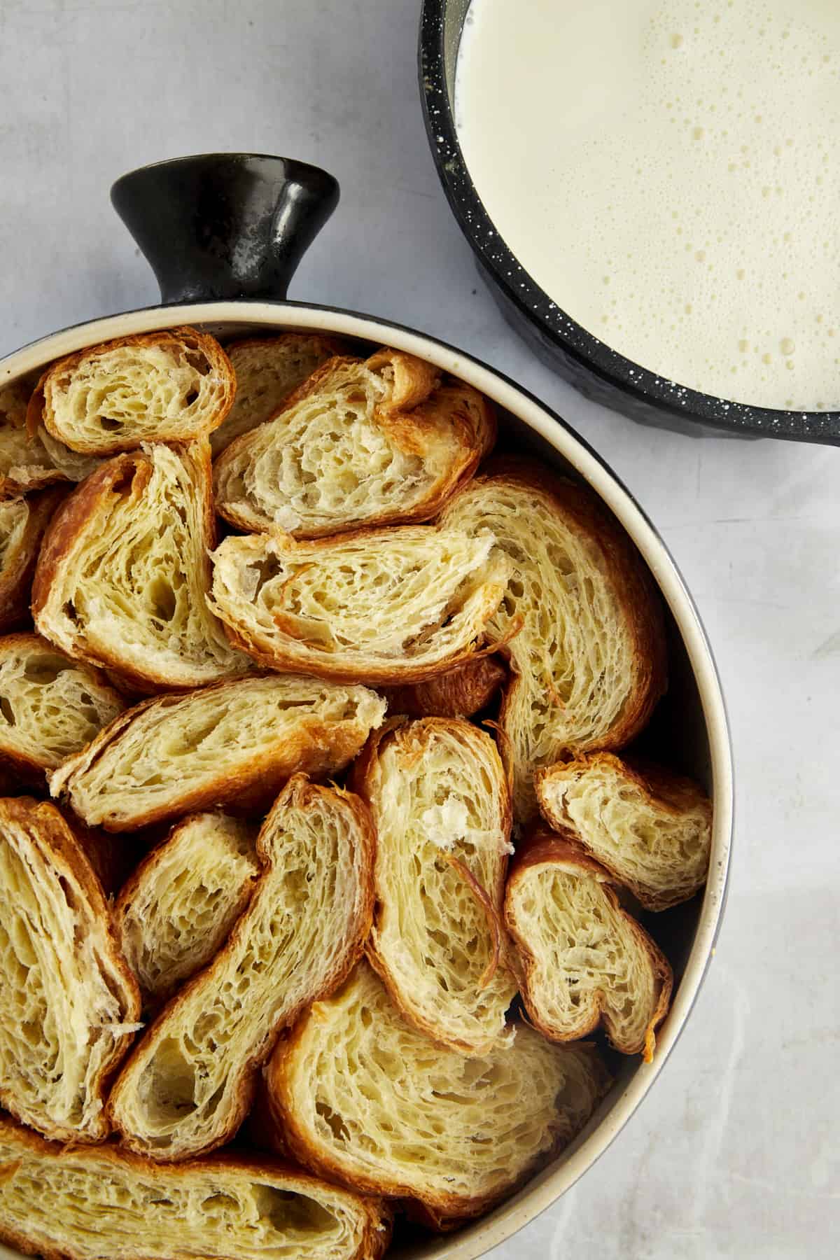 cubes of croissants in a single layer in a baking dish