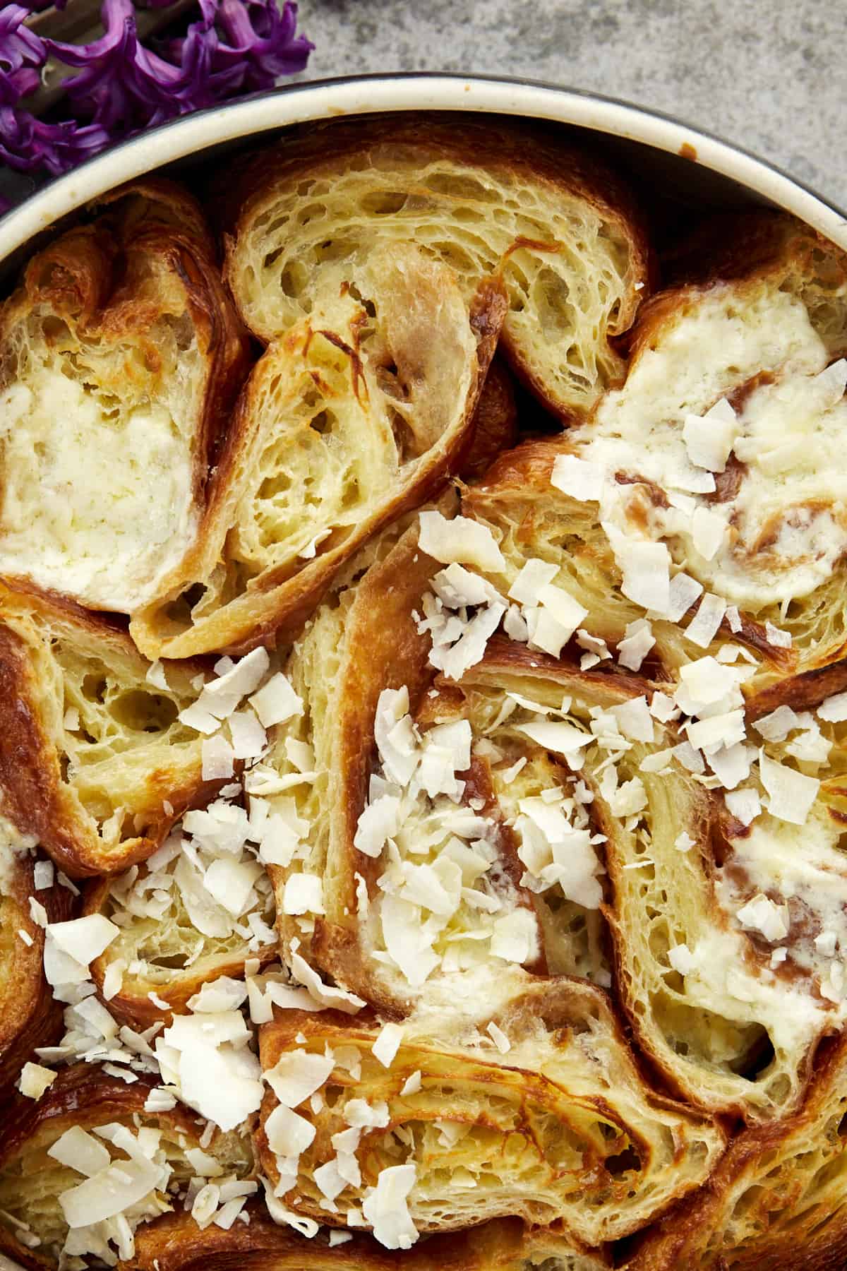 close up image of baked yawmiyat om ali topped with shredded coconut flakes