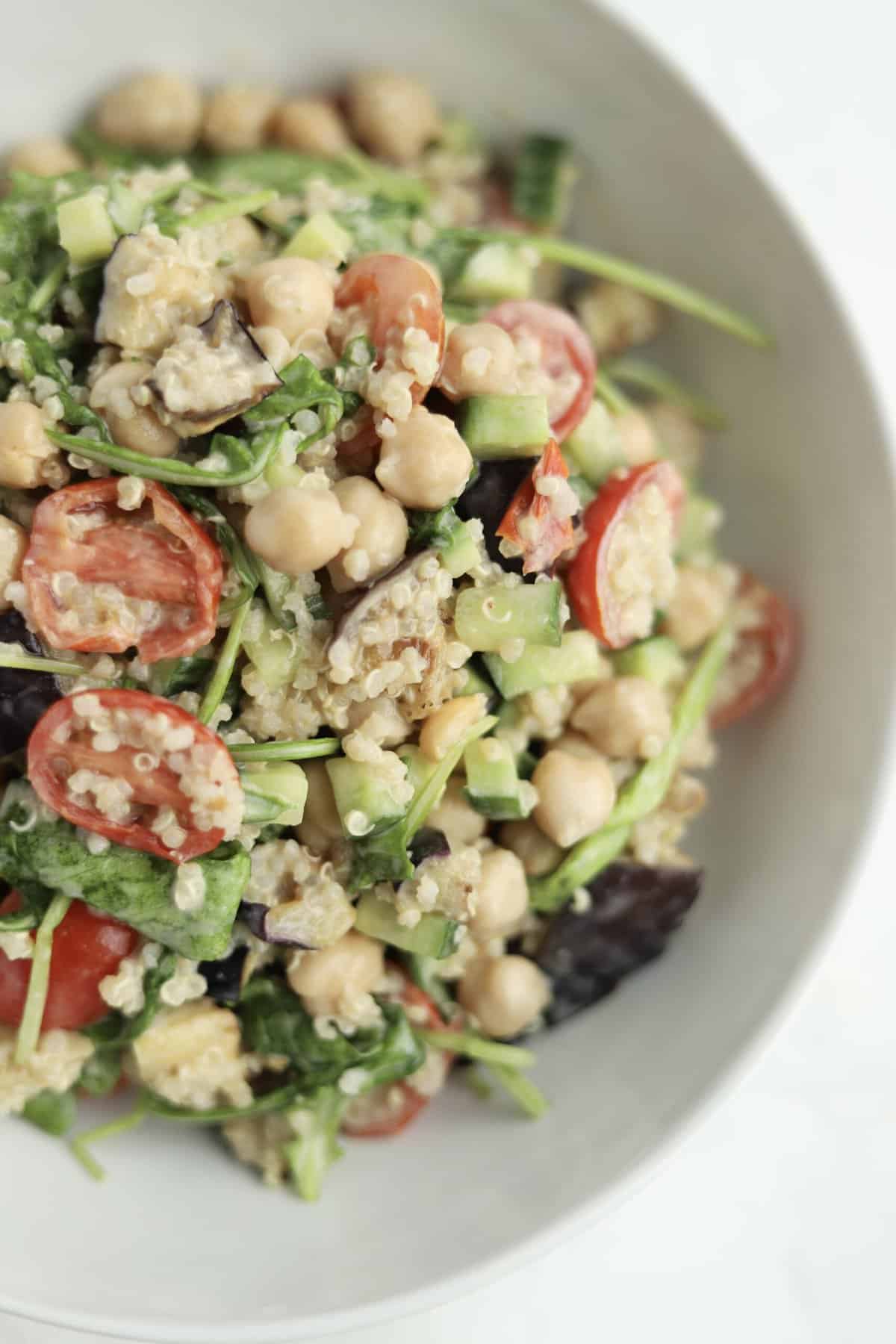 close up image of vegan roasted eggplant salad that has been tossed with a homemade tahini dressing