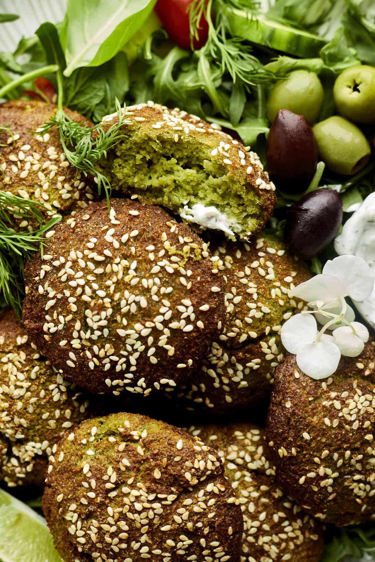 Falafel balls topped with white sesame seeds. 