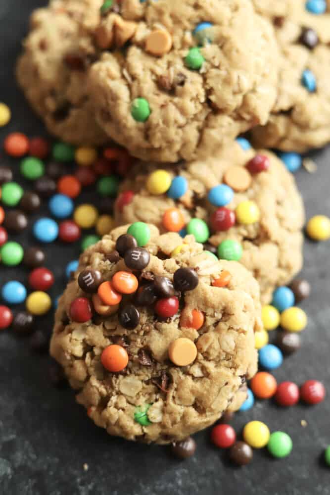 a pile of monster cookies topped with extra m&ms