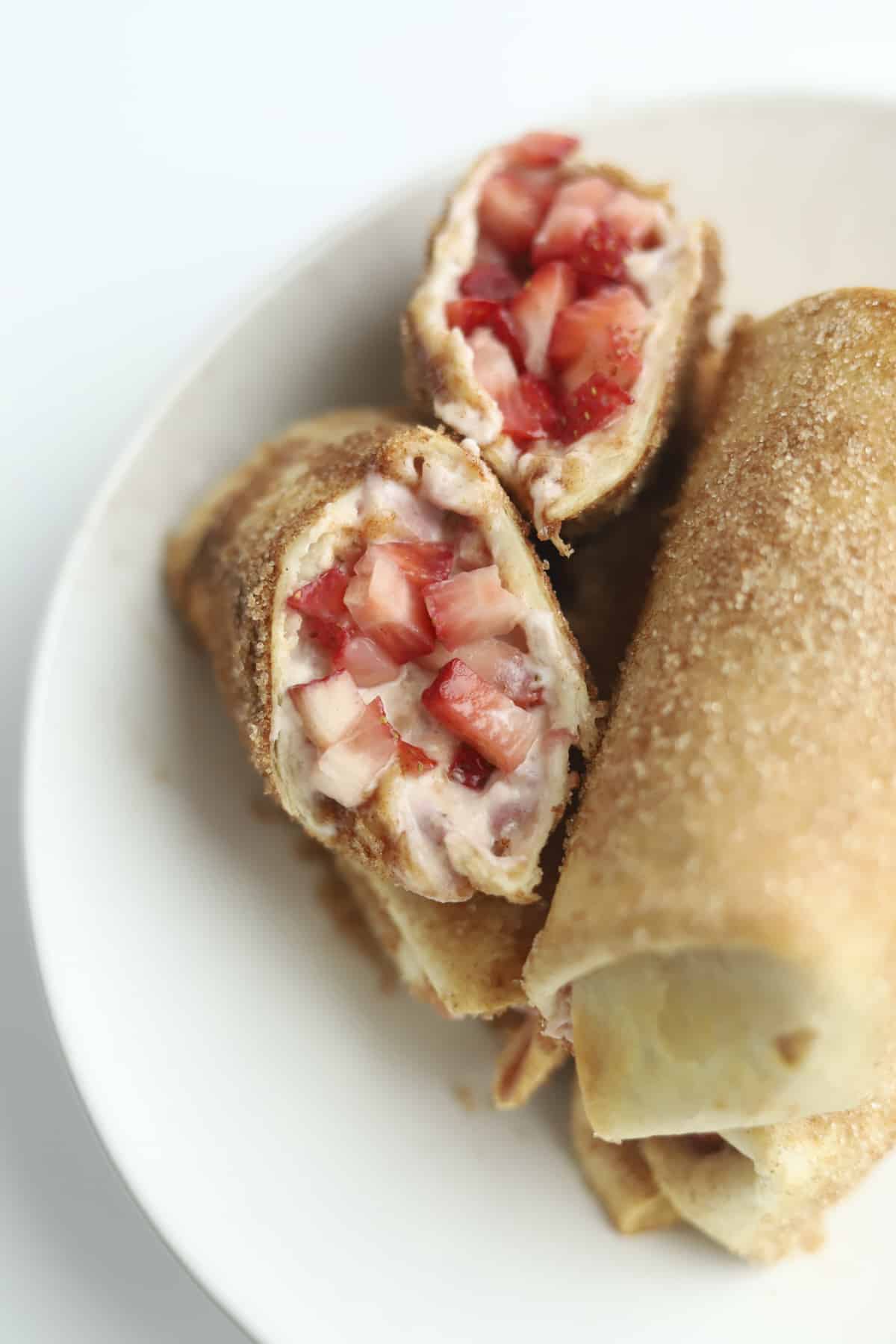 opened stuffed chimichanga with fresh strawberries