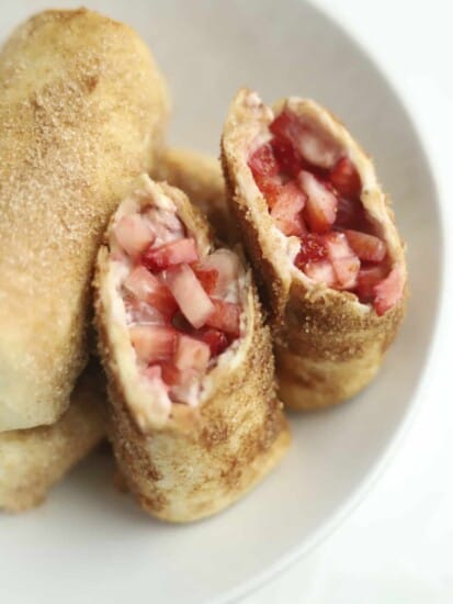 opened stuffed chimichanga with fresh strawberries