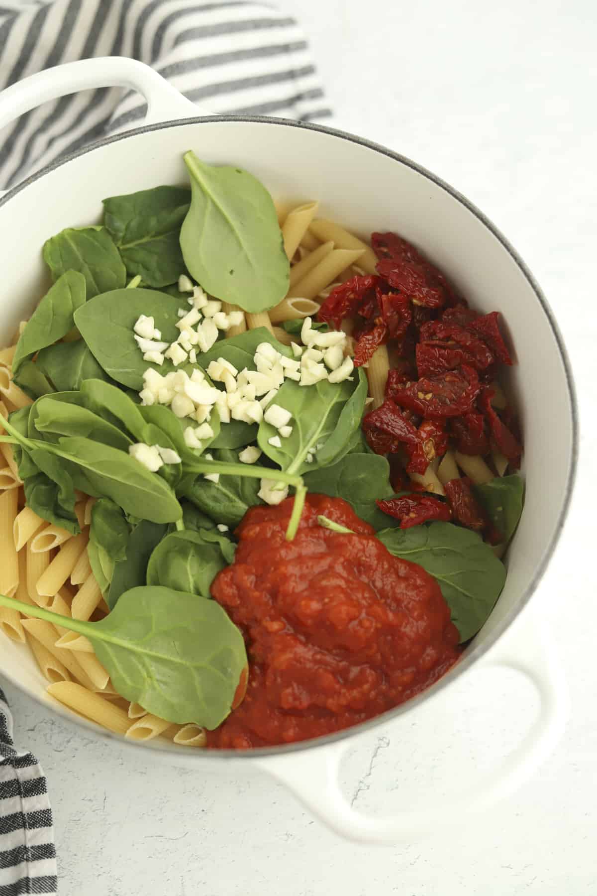 pot of penne with spinach, garlic, and marinara