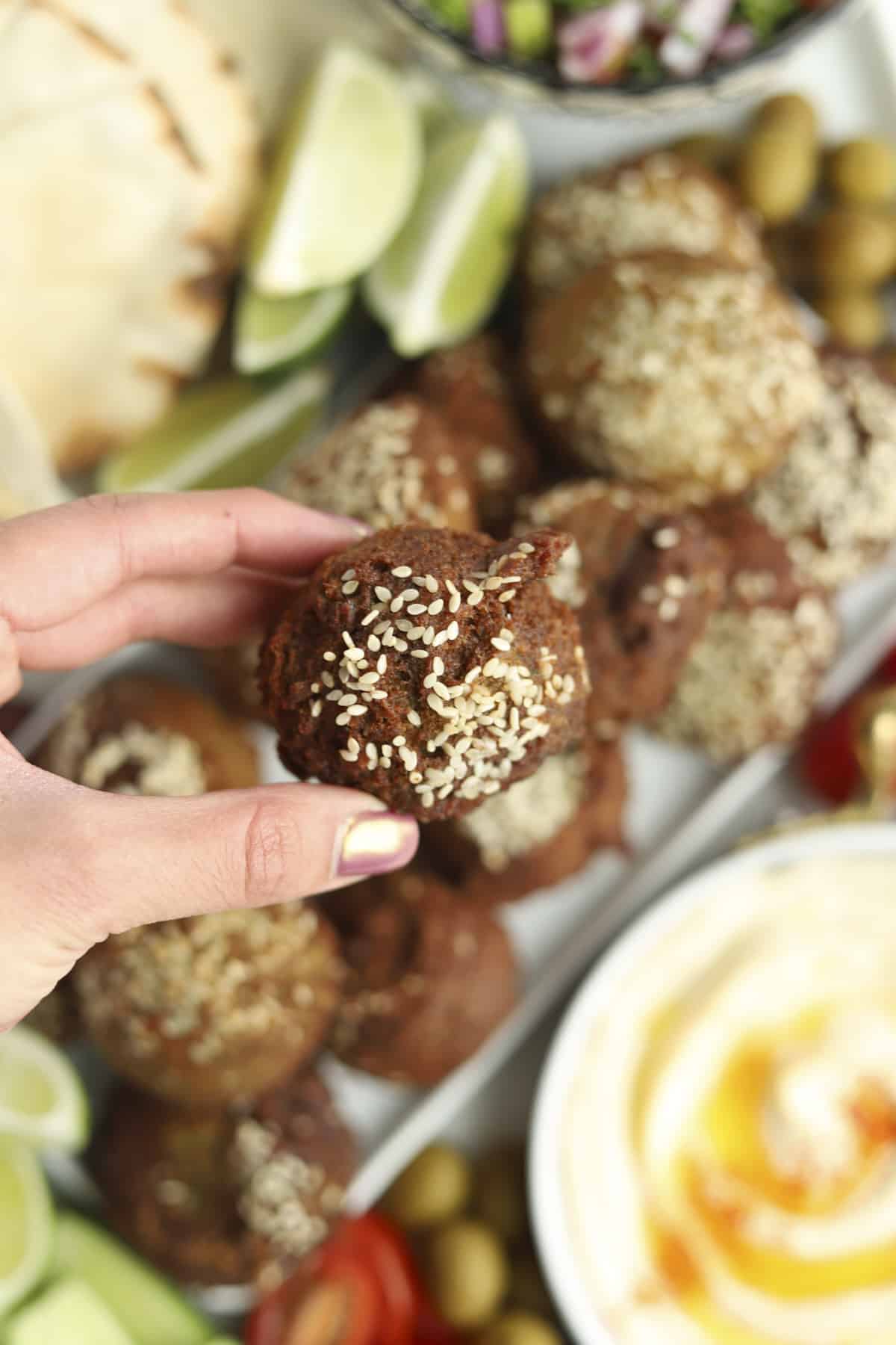 holding one ball of falafel 