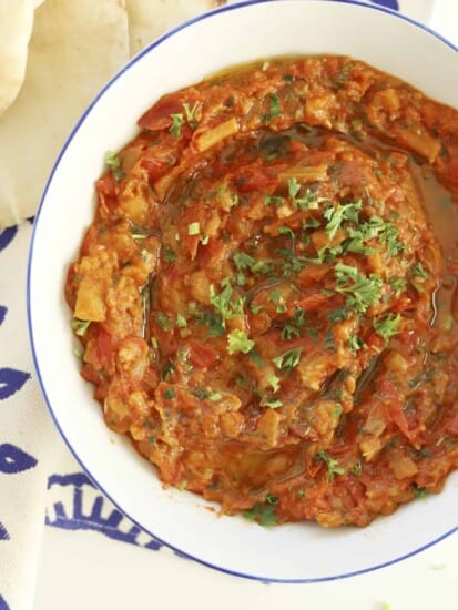 closeup overhead zaalouk with olive oil and fresh parsley