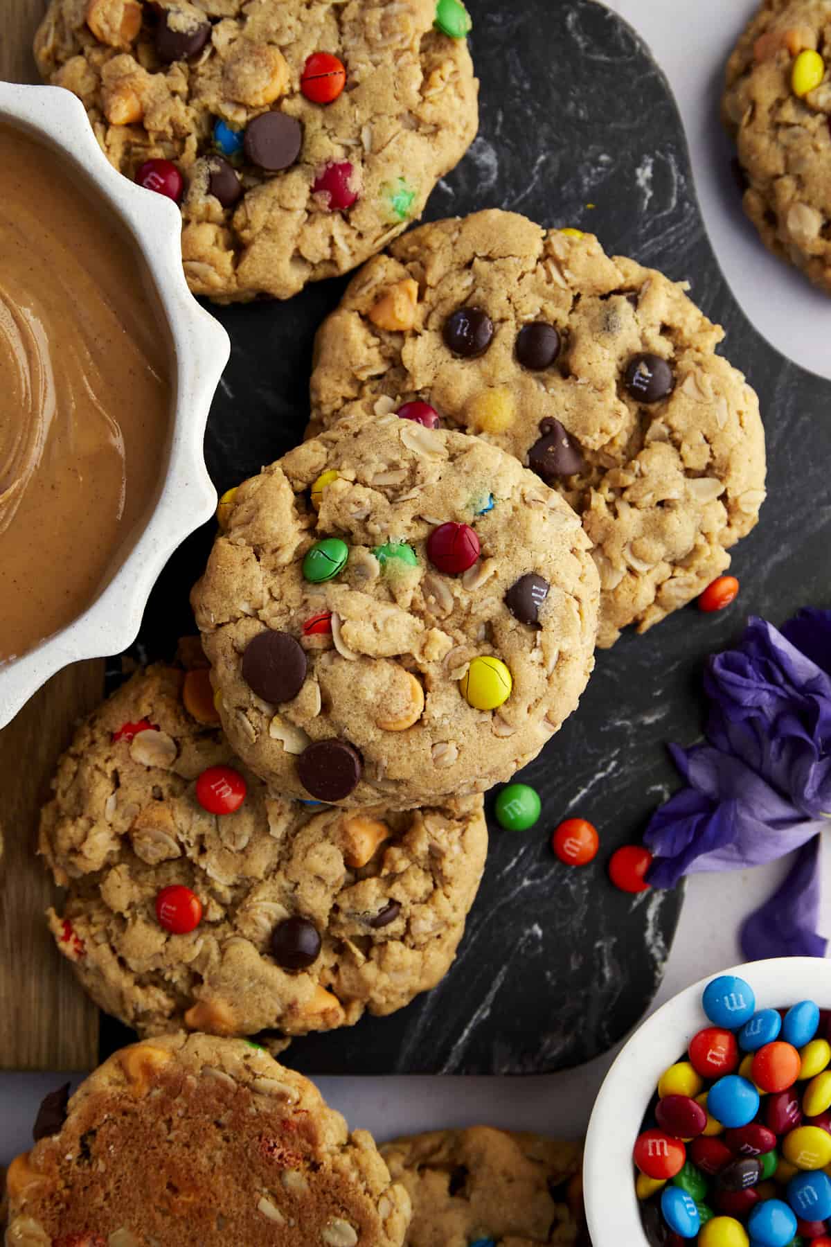 monster cookies next to bowls of peanut butter and M&M's
