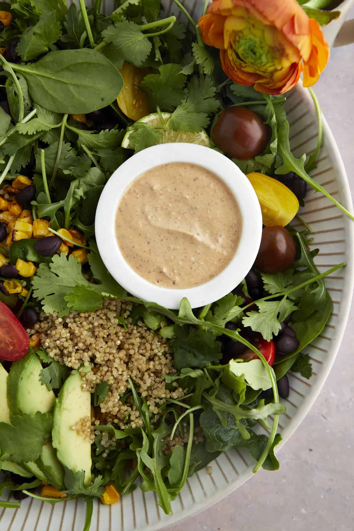 close up image of a bowl of dressing on top of a southwest salad