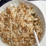 a bowl of vermicelli rice with a spoon on the side.
