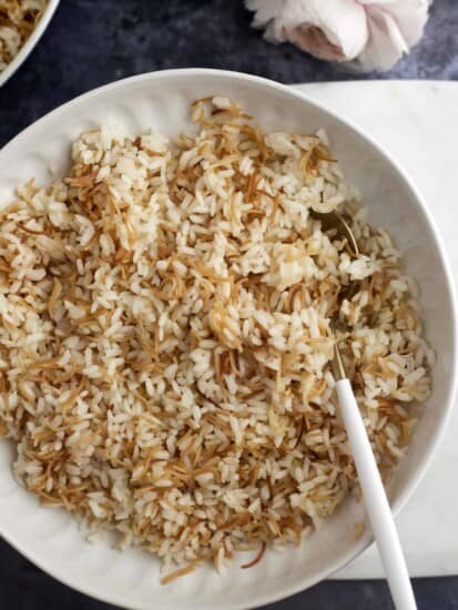a bowl of vermicelli rice with a spoon on the side.