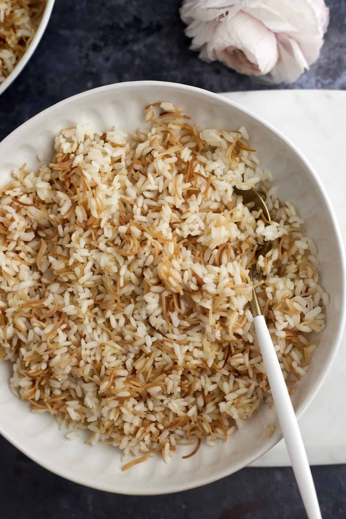 a bowl of vermicelli rice with a spoon on the side.