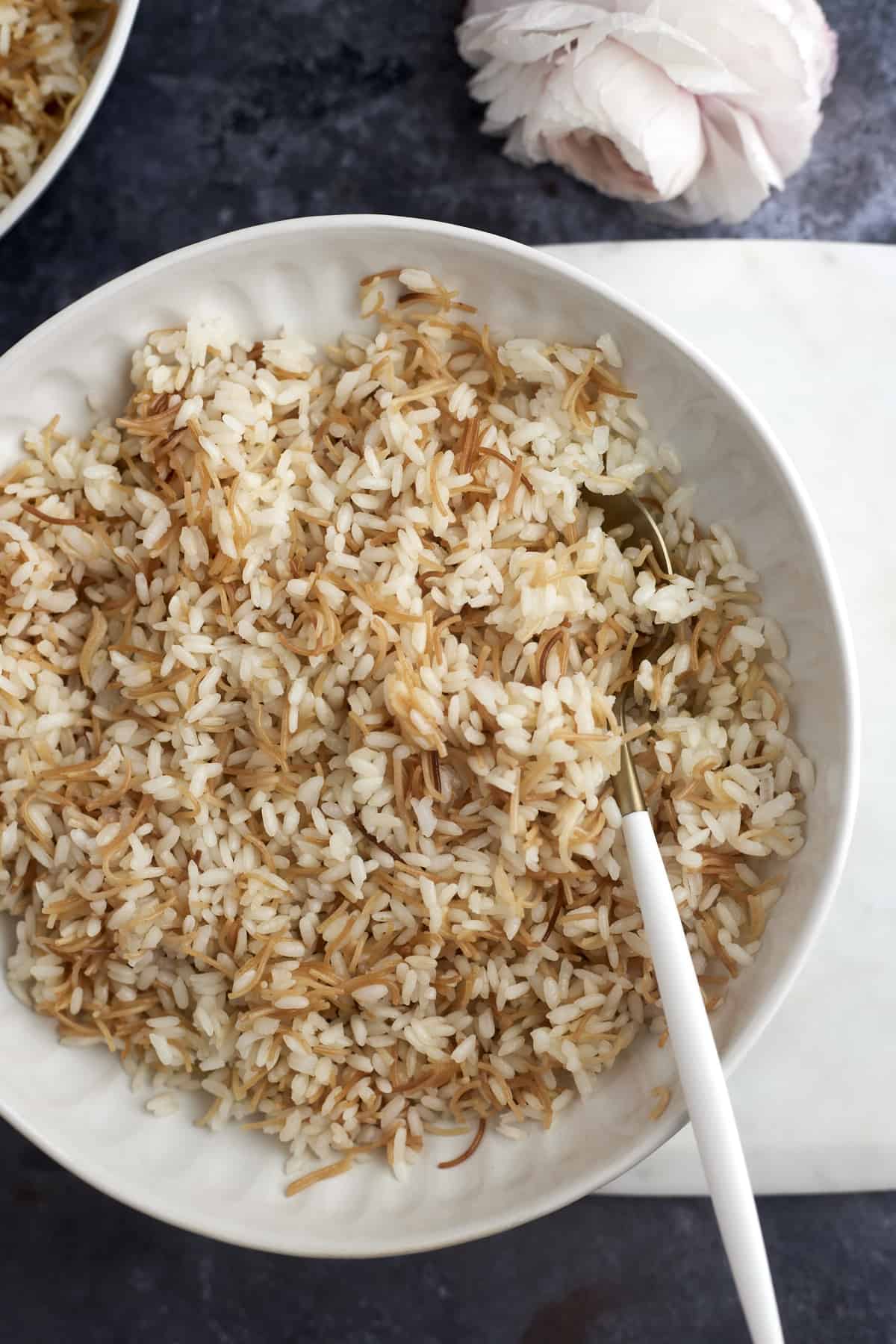 a white bowl full of vermicelli rice.