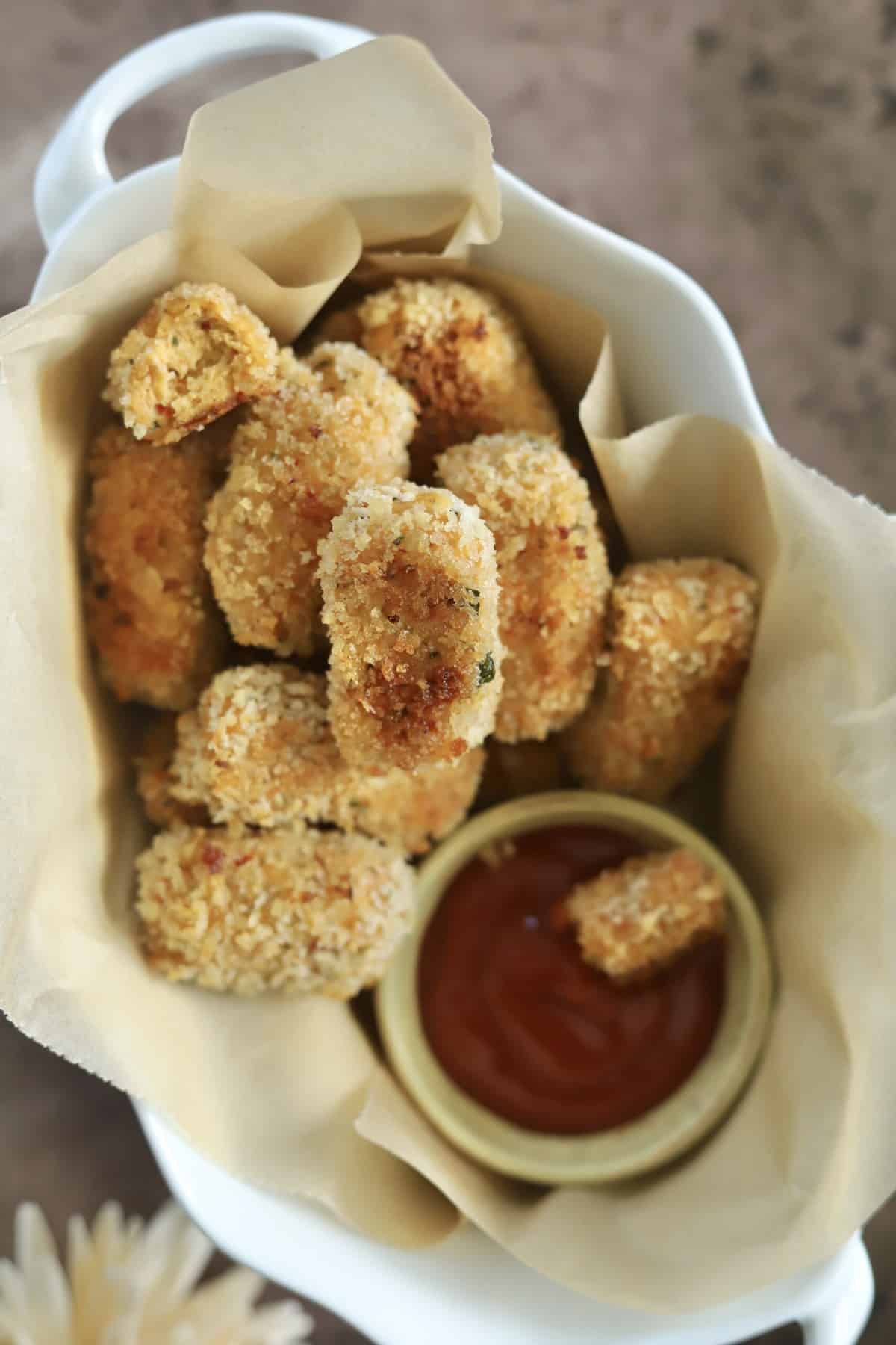 closeup overhead baked chicken nuggets with ketchup.