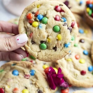 hand holding one large m&m cookie