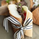Beef po boy sandwich wrapper in a back and white ribbon