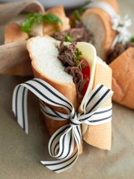 Beef po boy sandwich wrapper in a back and white ribbon