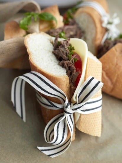 Beef po boy sandwich wrapper in a back and white ribbon