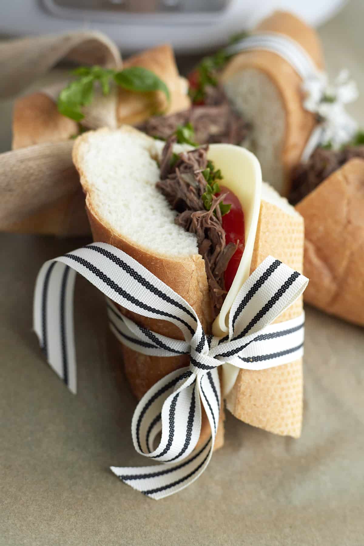 po' boy sandwich wrapped in blue and white ribbon