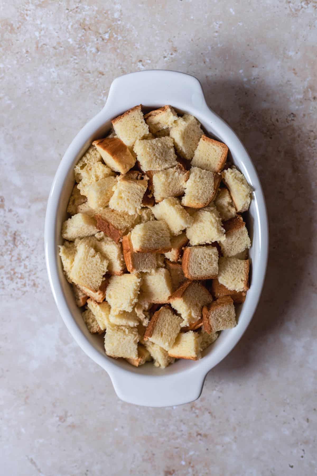 pieces of bread in an oval baking dish