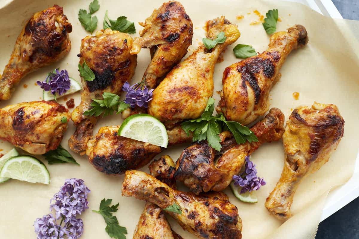 baked peri peri chicken drumsticks on parchment paper 