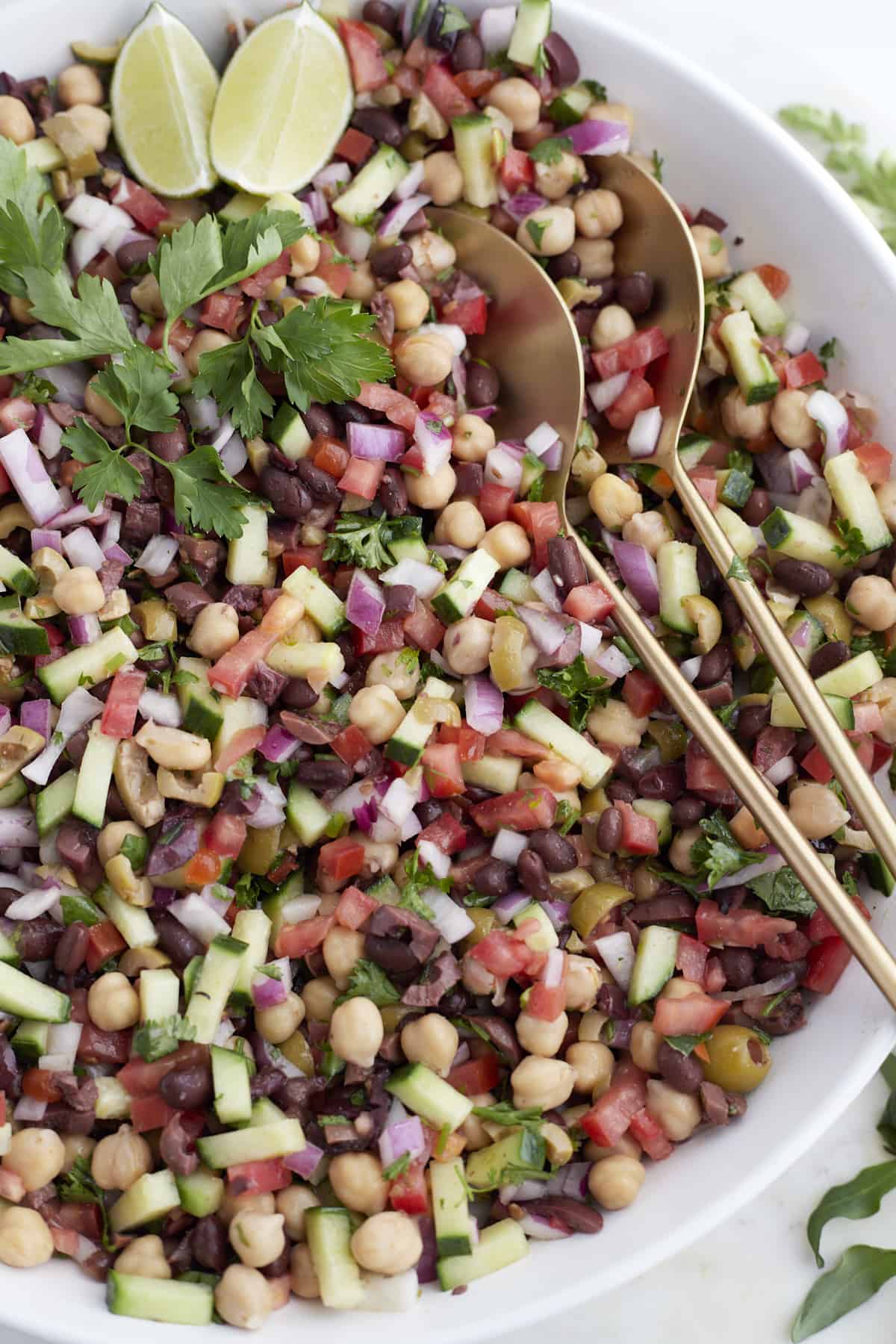 close up image of a Mediterranean chickpea salad recipe in a large white bowl