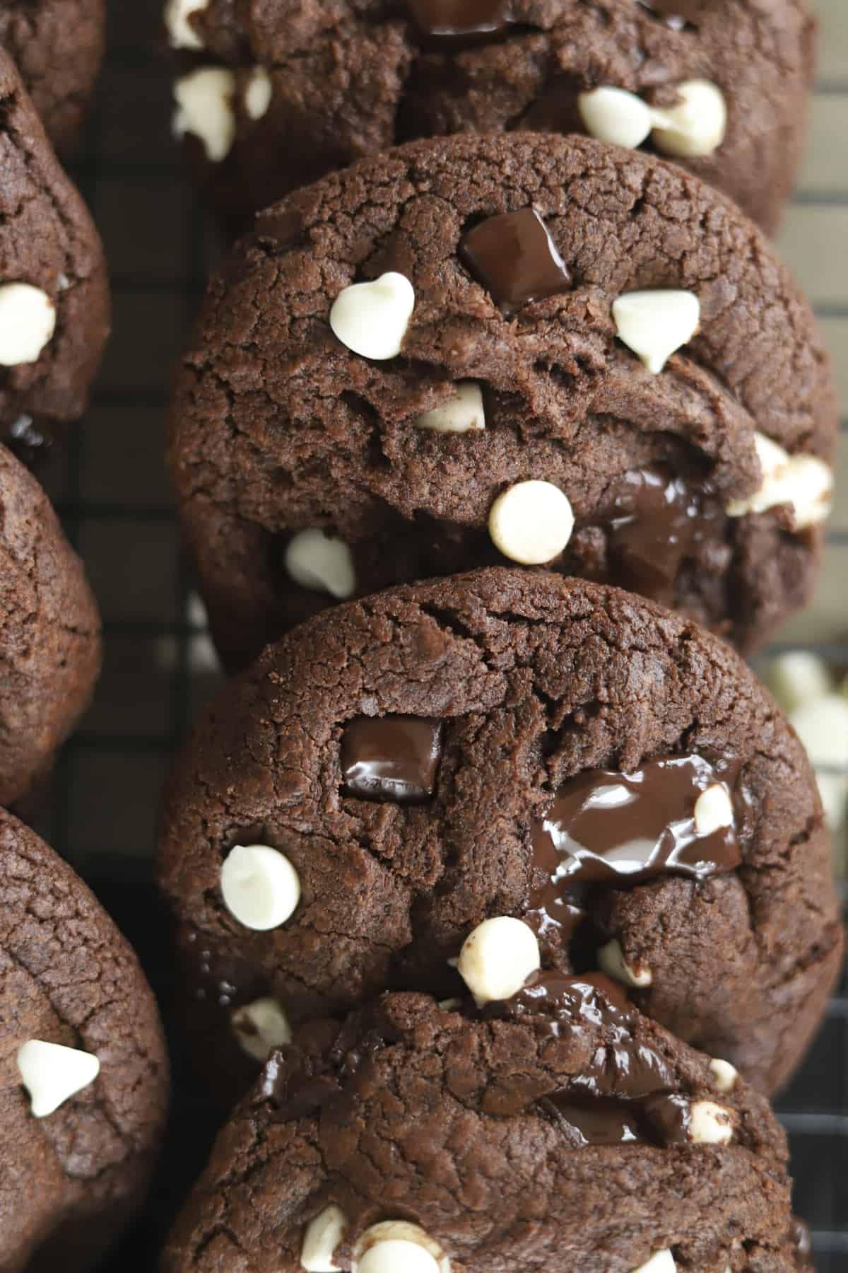 stacked double chocolate chunk cookies on a cooling rack