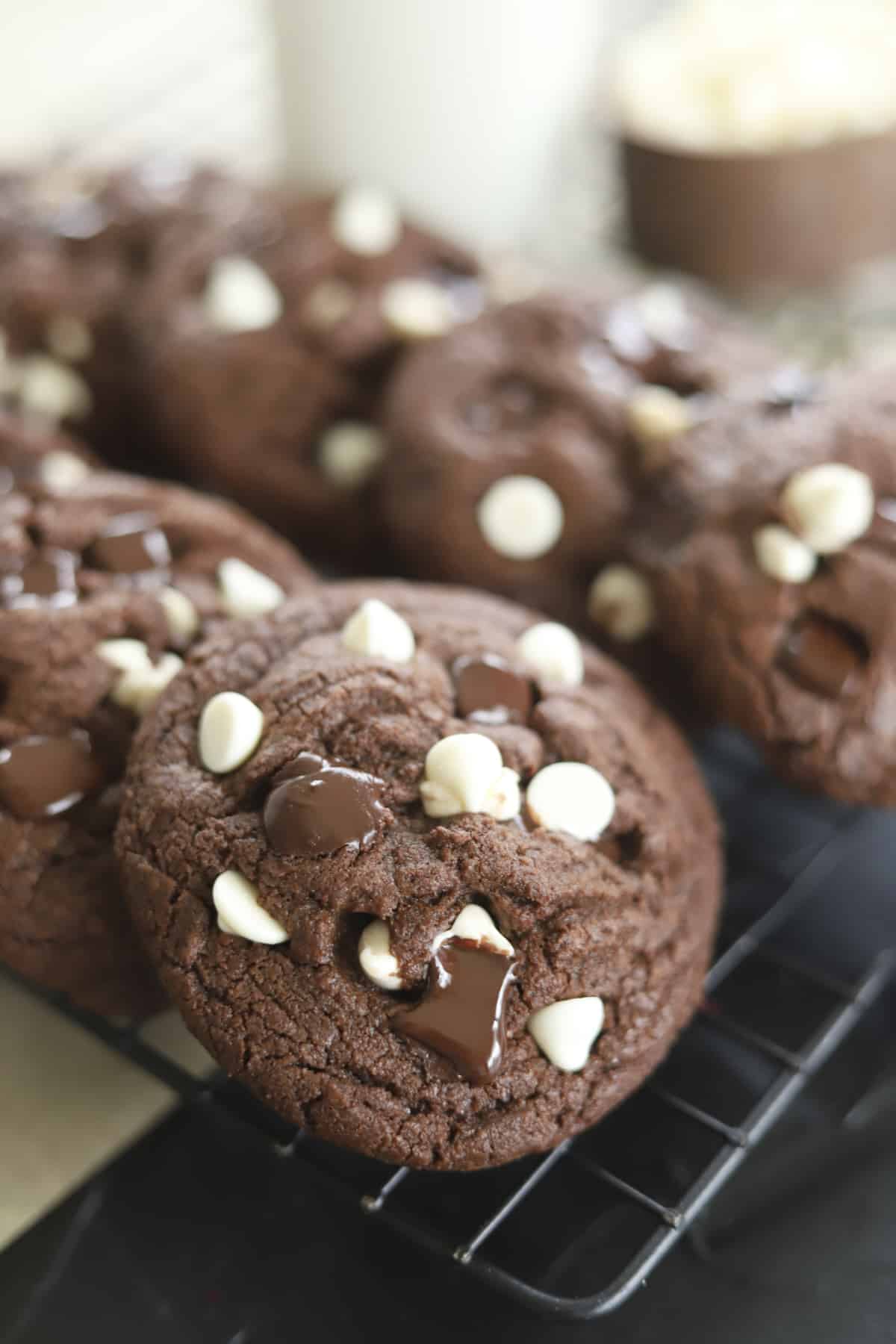 closeup double chocolate chunk cookies on a cooling rack