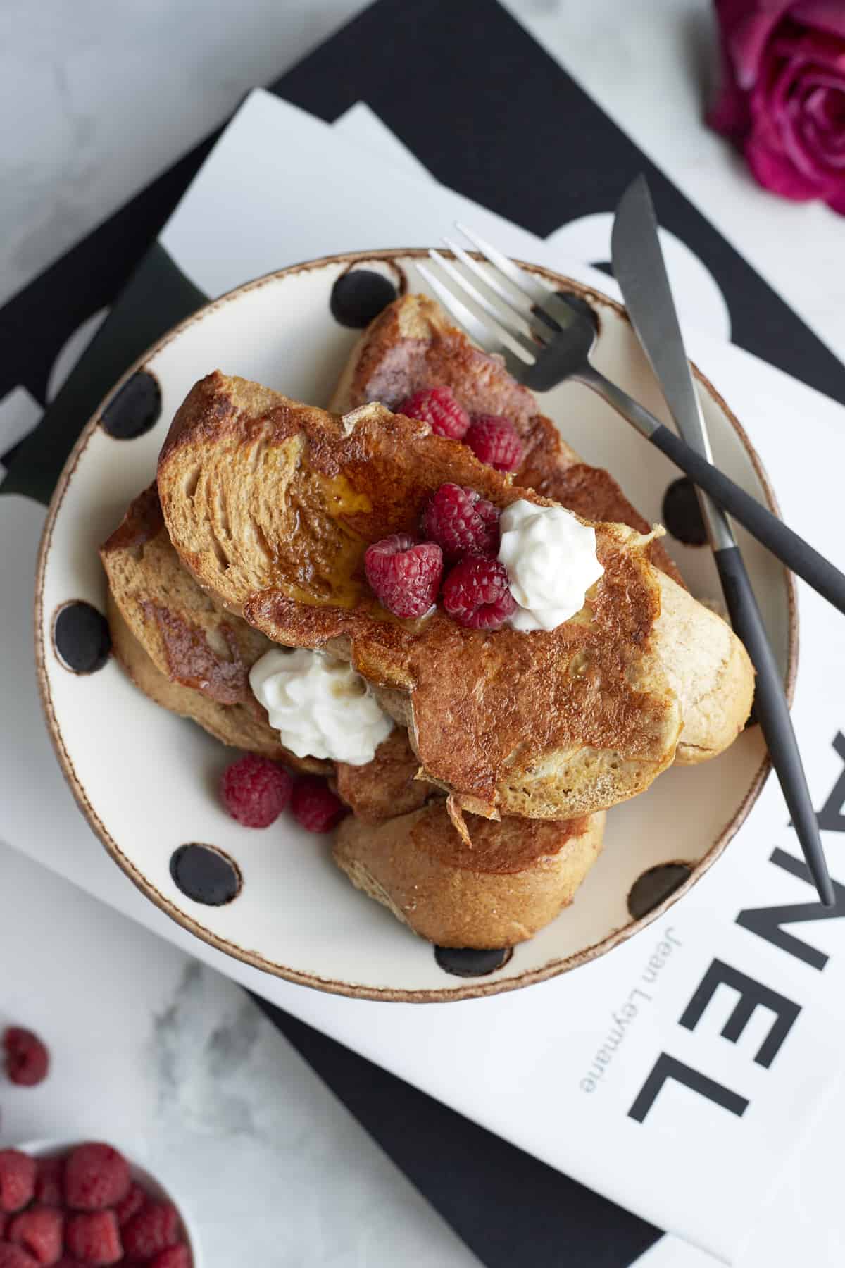 plated sheet pan french toast with raspberries and whipped cream